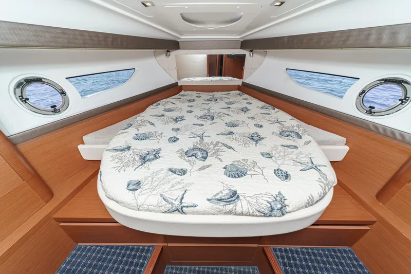 Slide: The Image of Luxurious cabin interior of 2014 Beneteau Gran Turismo 38 yacht with nautical-themed bedding. - 47