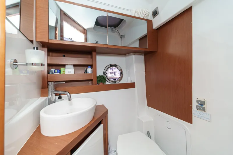 Slide: The Image of Luxurious bathroom in 2014 Beneteau Gran Turismo 38 yacht, featuring modern fixtures and wood accents. - 49