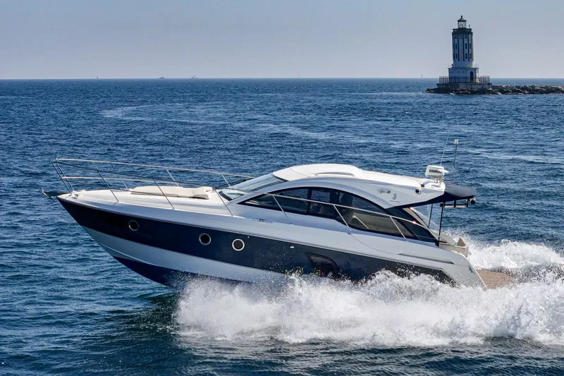 Slide: The Image of 2014 Beneteau Gran Turismo 38 yacht cruising near a lighthouse on open sea. - 8