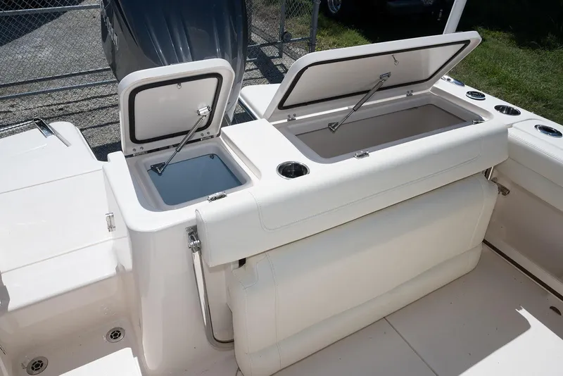 Slide: The Image of 2023 Grady-White Freedom 235 boat with open storage compartments. - 10