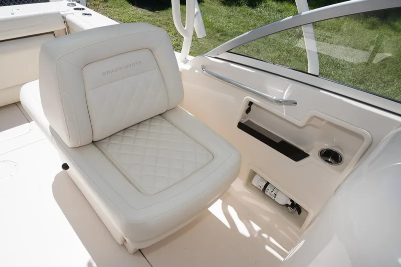 Slide: The Image of 2023 Grady-White Freedom 235 boat interior with white cushioned seating. - 13
