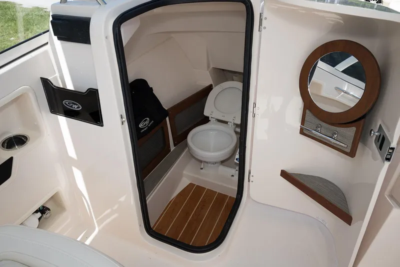 Slide: The Image of 2023 Grady-White Freedom 235 boat interior with toilet and mirror. - 20