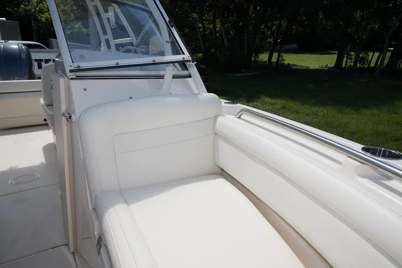 Slide: The Image of 2023 Grady-White Freedom 235 boat interior with white seating and windshield. - 25