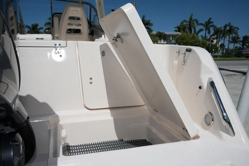 Slide: The Image of 2023 Grady-White Freedom 235 boat storage compartment with open hatch, showcasing interior details. - 7