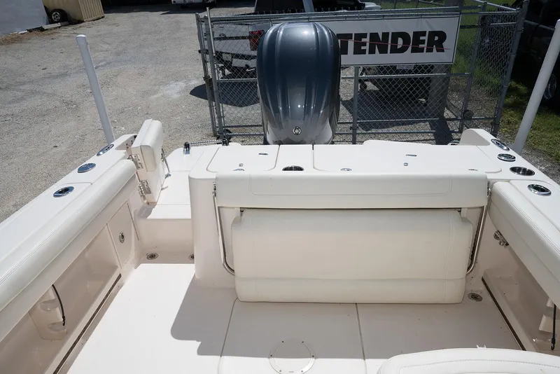 Slide: The Image of 2023 Grady-White Freedom 235 boat interior with seating and engine view. - 9