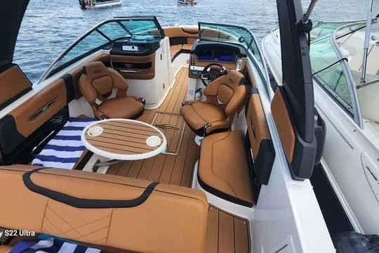 Slide: The Image of 2023 Chaparral 267 SSX boat on display, sleek design, parked outdoors. - 3