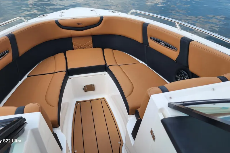 Slide: The Image of 2023 Chaparral 267 SSX boat interior with tan leather seating and wood flooring. - 5