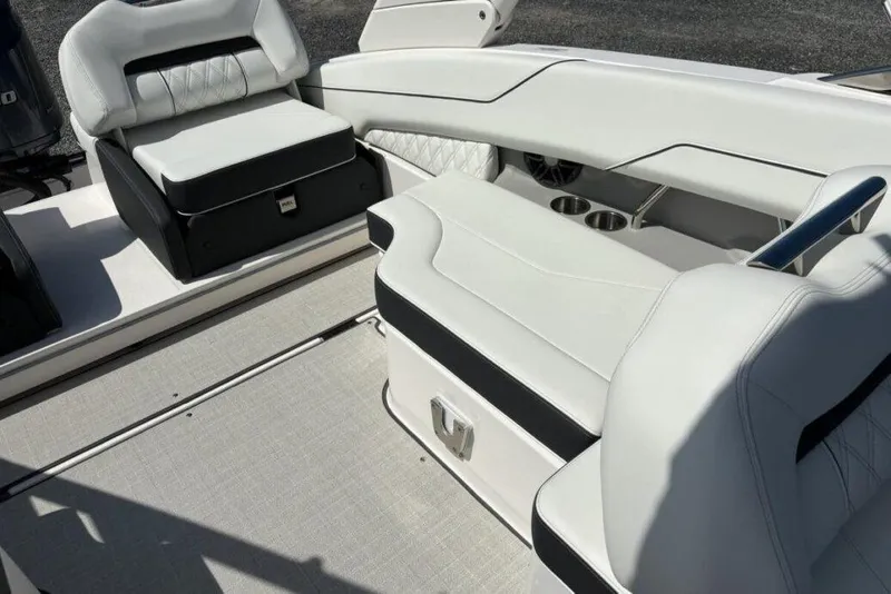 Slide: The Image of 2023 Regal LX4 boat interior with white leather seating and cup holders. - 13