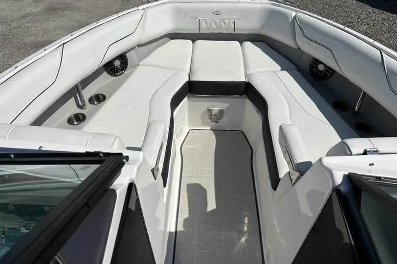 Slide: The Image of 2023 Regal LX4 boat interior with white seating and cup holders. - 3