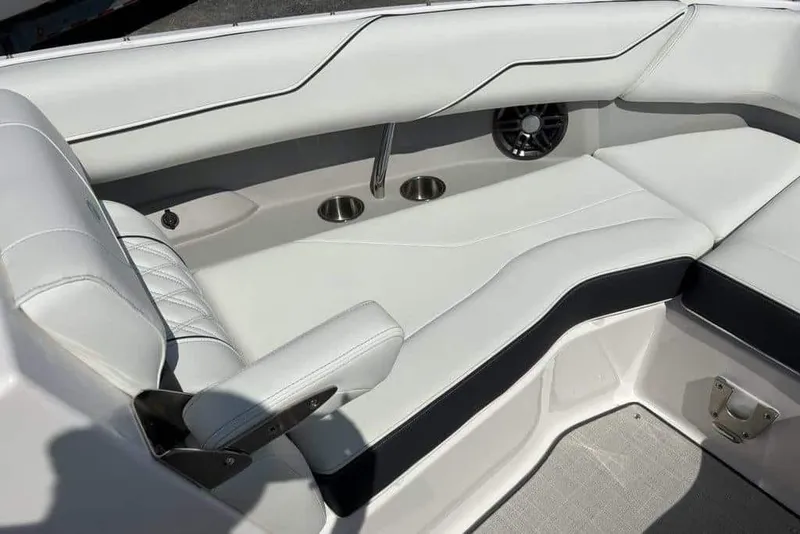 Slide: The Image of 2023 Regal LX4 boat interior with white leather seating, cup holders, and speaker. - 5