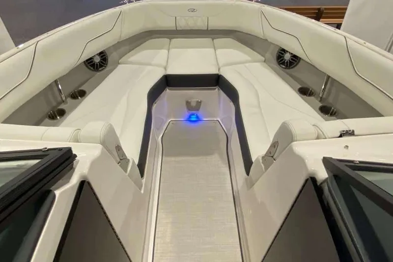 Slide: The Image of 2023 Regal LX4 boat interior with white seating and cup holders. - 7