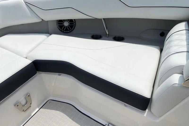 Slide: The Image of 2023 Regal LX4 boat interior with white cushioned seating and cup holders. - 8