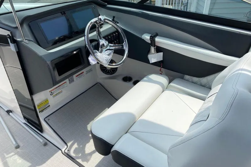 Slide: The Image of 2023 Regal LX4 boat cockpit with modern steering and plush seating. - 9