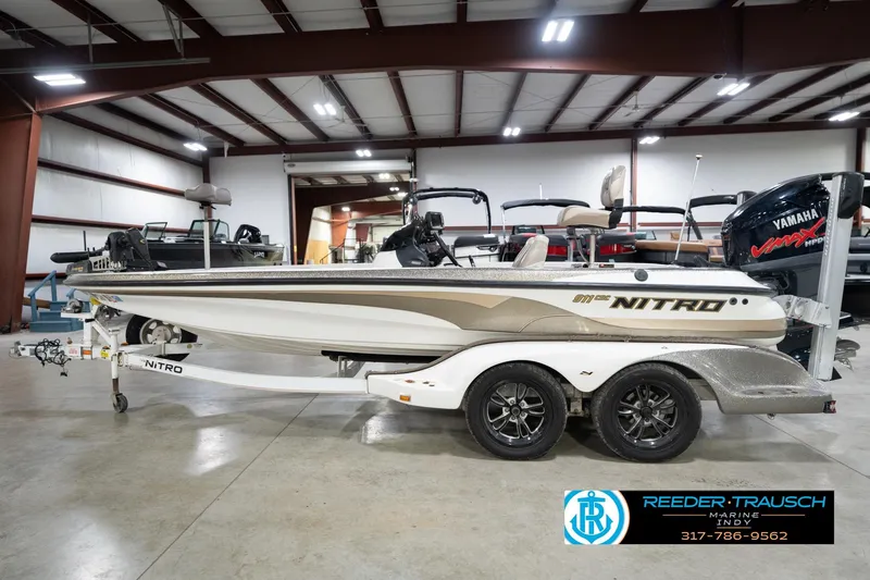 Slide: The Image of 2003 Nitro 911 CDC boat deck with trolling motor and carpeted surface. - 10
