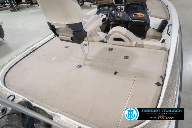 Slide: The Image of 2003 Nitro 911 CDC boat interior with steering wheel and dashboard in a spacious garage. - 13