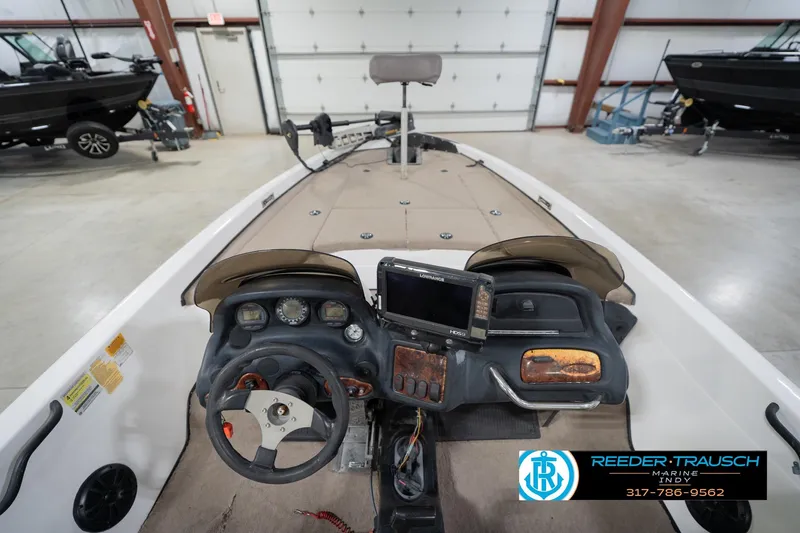 Slide: The Image of 2003 Nitro 911 CDC boat in a showroom with various pontoon boats. - 16