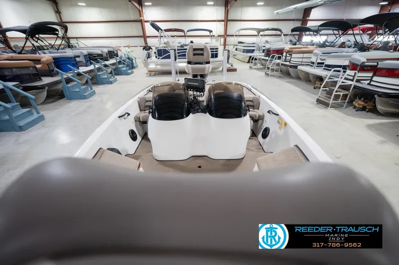 Slide: The Image of 2003 Nitro 911 CDC boat interior with beige seating and carpeted deck at Reeder Trausch Marine. - 18