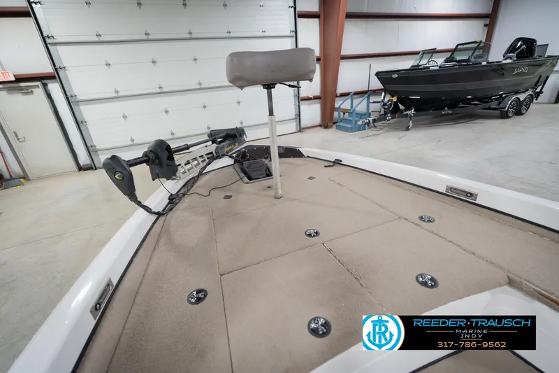 Slide: The Image of 2003 Nitro 911 CDC boat interior with open storage compartments in a garage. - 24