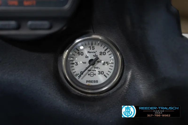 Slide: The Image of Dashboard switches of a 2003 Nitro 911 CDC boat, featuring wood paneling. - 34