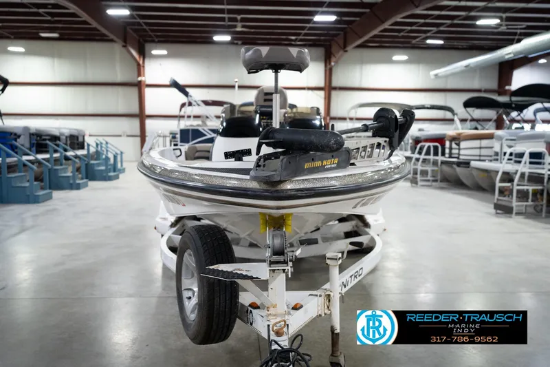 Slide: The Image of 2003 Nitro 911 CDC boat in showroom, featuring dual-axle trailer and Yamaha engine. - 4