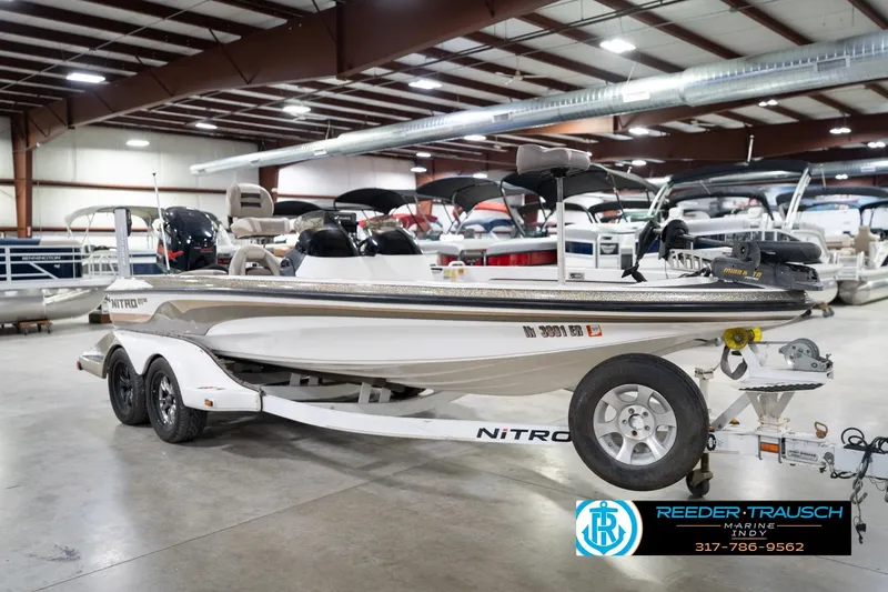 Slide: The Image of 2003 Nitro 911 CDC boat with Yamaha engine in showroom, displayed on trailer. - 5