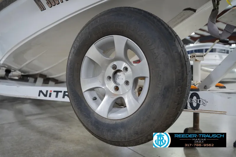 Slide: The Image of Close-up of a 2003 Nitro 911 CDC boat interior with chrome handle and electrical plug. - 58