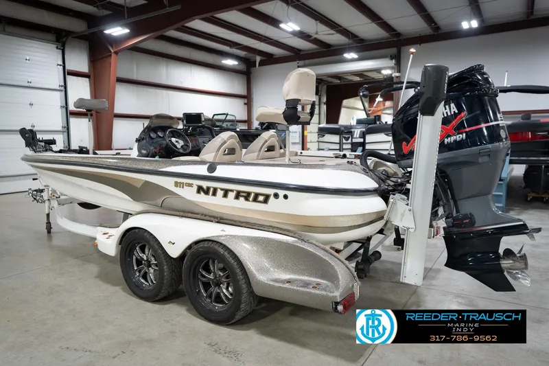 Slide: The Image of 2003 Nitro 911 CDC boat interior with fishing deck and trolling motor. - 9