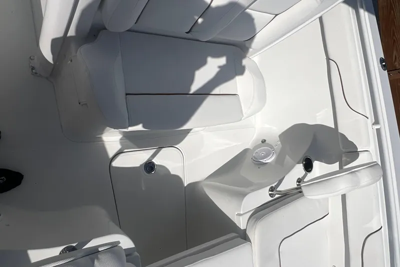 Slide: The Image of 2019 Sea Hunt Gamefish 25 boat interior with white seating and storage compartments. - 10