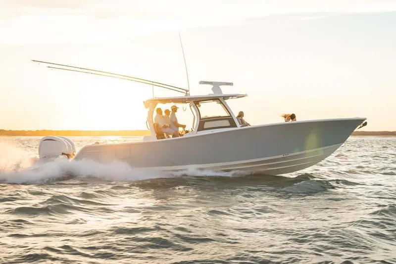 Slide: The Image of Manufacturer Provided Image: 2025 Sportsman Open 352 Center Console boat cruising at sunset on the ocean. - 2