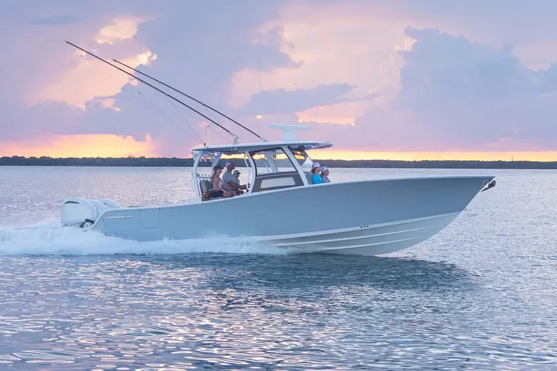 Slide: The Image of Manufacturer Provided Image: 2025 Sportsman Open 352 Center Console boat cruising at sunset on calm waters. - 3