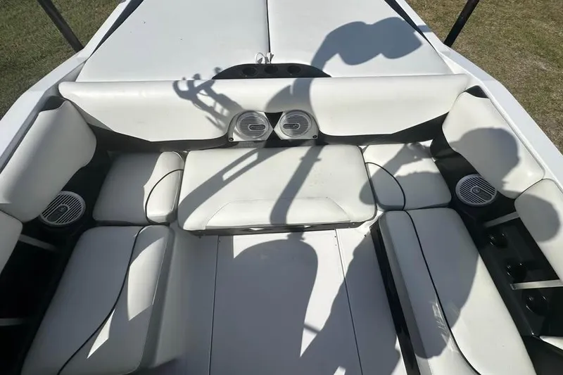 Slide: The Image of Interior of 2012 Axis A20 boat with white seating and built-in speakers. - 5