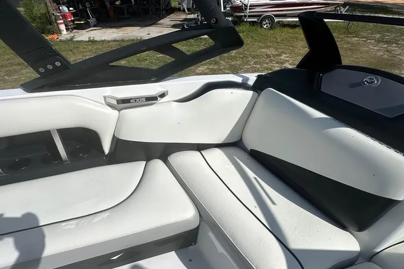 Slide: The Image of Interior of a 2012 Axis A20 boat with white seating and black accents. - 6