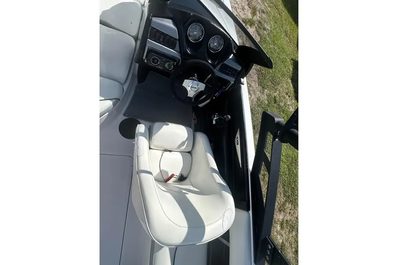 Slide: The Image of 2012 Axis A20 boat interior with white seating and control dashboard. - 8