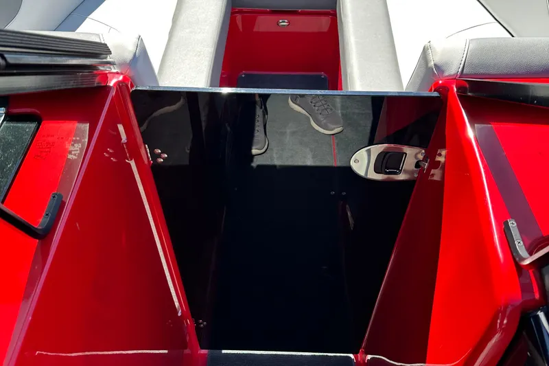 Slide: The Image of 2021 MasterCraft NXT24 boat interior with red and black accents. - 13