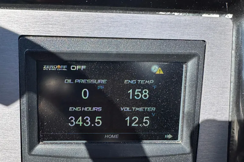 Slide: The Image of Dashboard display of a 2021 MasterCraft NXT24 showing engine metrics and GPS speed control. - 17