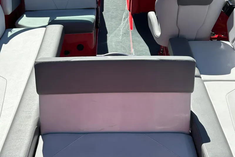 Slide: The Image of 2021 MasterCraft NXT24 boat interior with gray and white seating arrangement. - 9