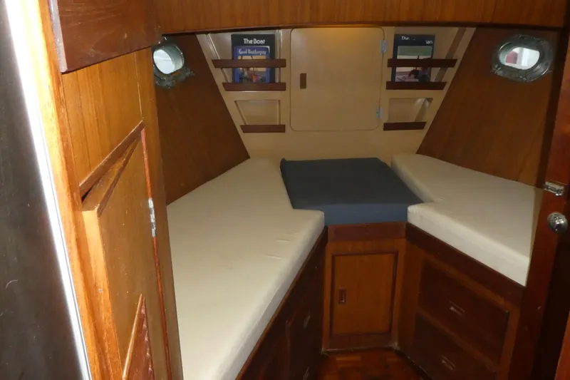Slide: The Image of 1979 Hiptimco 40' Trawler cabin interior with wooden finish and twin beds. - 11