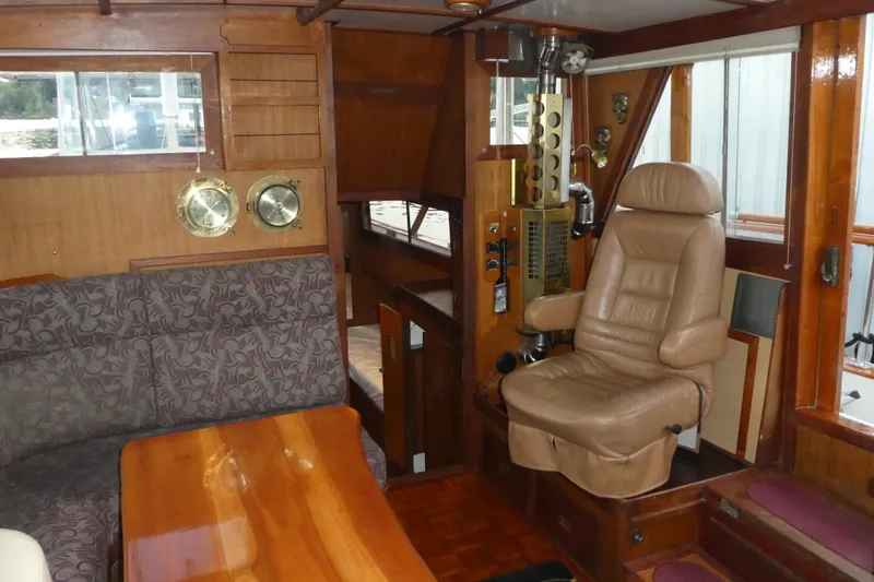 Slide: The Image of Interior of a 1979 Hiptimco 40' Trawler with leather captain's chair and wood accents. - 14