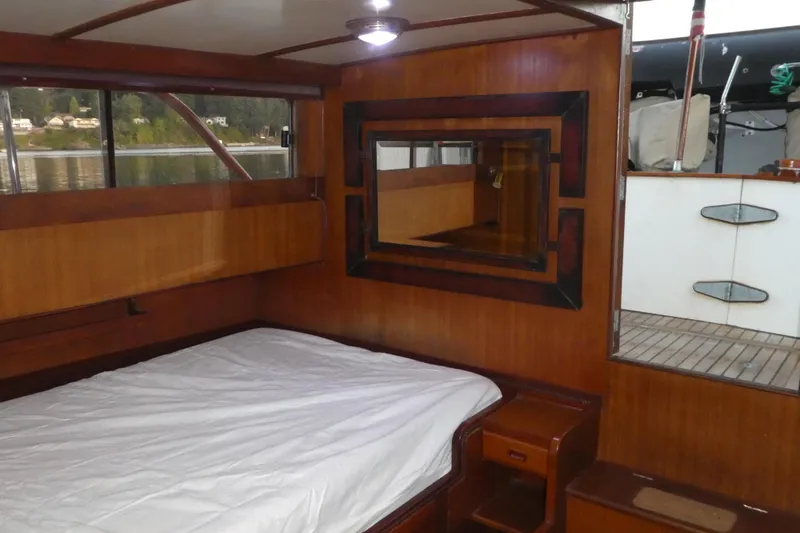 Slide: The Image of Cozy cabin interior of 1979 Hiptimco 40' Trawler with wood paneling and bed. - 16
