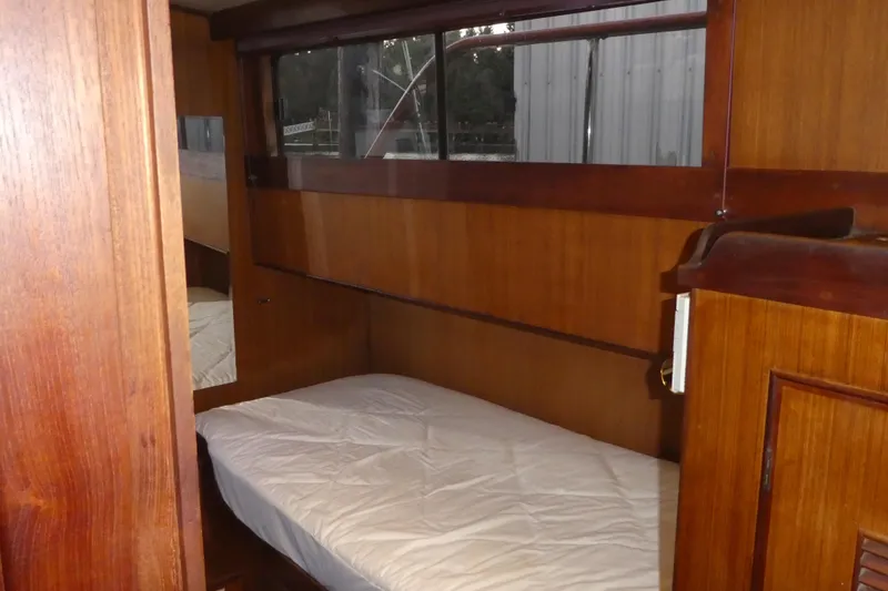 Slide: The Image of 1979 Hiptimco 40' Trawler cabin interior with wooden paneling and a single bed. - 18