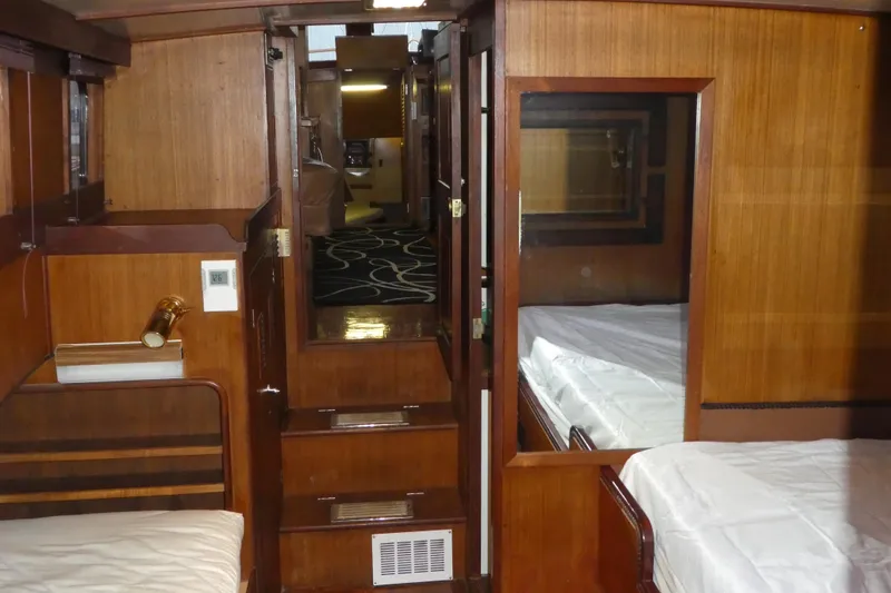 Slide: The Image of Interior of 1979 Hiptimco 40' Trawler with wooden paneling and cozy cabin layout. - 19