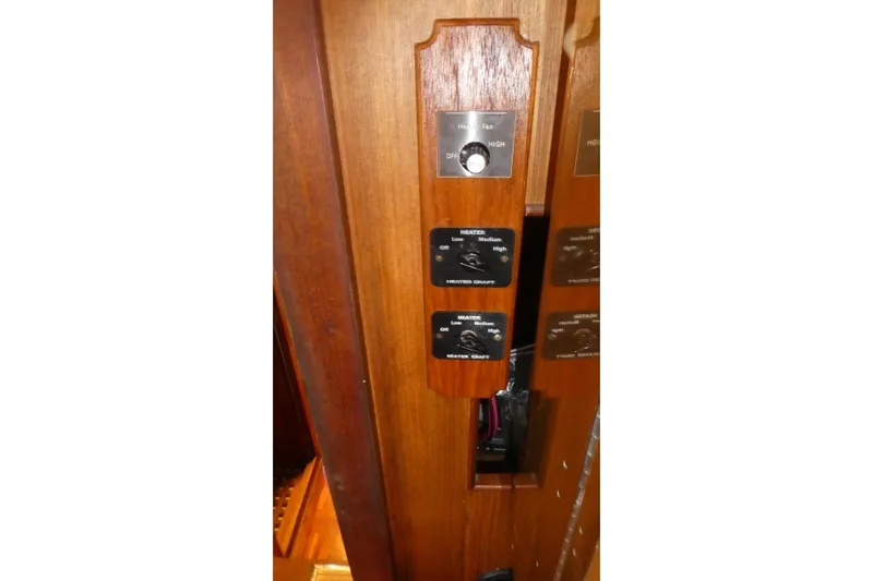 Slide: The Image of Wooden control panel on a 1979 Hiptimco 40' Trawler with heater settings. - 27