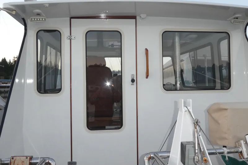 Slide: The Image of 1979 Hiptimco 40' Trawler, rear view with windows and door, docked at marina. - 29
