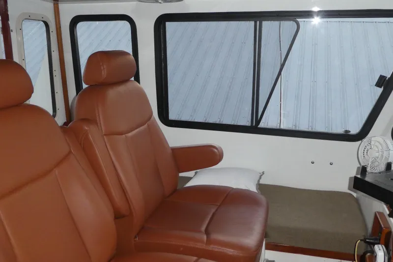 Slide: The Image of Interior of 1979 Hiptimco 40' Trawler with brown leather seats and large windows. - 32
