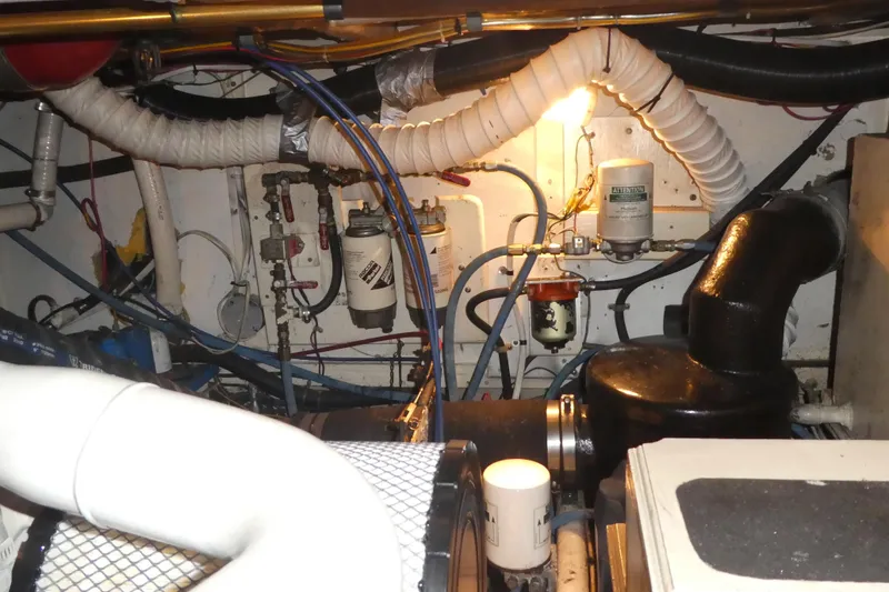 Slide: The Image of Engine room of a 1979 Hiptimco 40' Trawler with visible pipes and filters. - 42