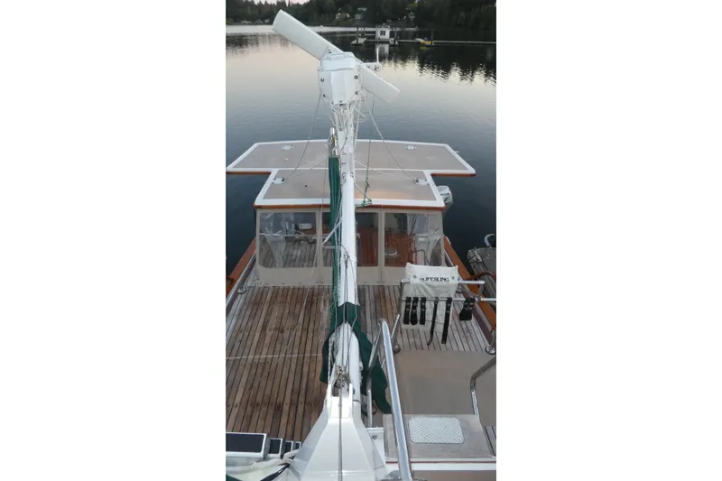 Slide: The Image of 1979 Hiptimco 40' Trawler on calm water, showcasing deck and equipment. - 48