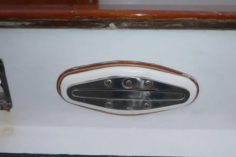 Slide: The Image of 1979 Hiptimco 40' Trawler, metal fitting detail on white surface. - 52