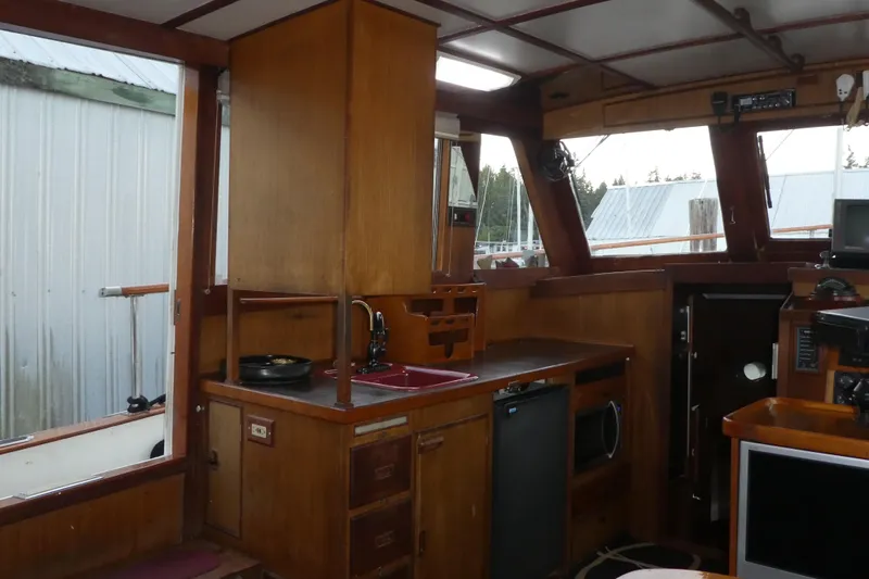 Slide: The Image of Interior of 1979 Hiptimco 40' Trawler with wooden cabinetry and kitchen area. - 7