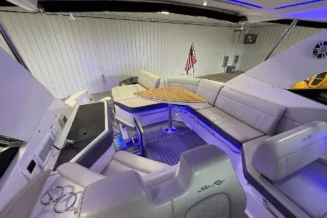 Slide: The Image of Luxurious 2021 Sea Ray 320 Sundancer boat interior with elegant seating and ambient lighting. - 4