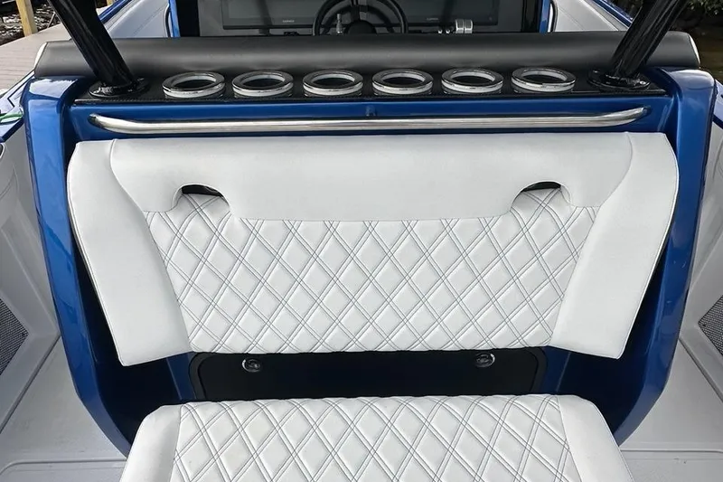 Slide: The Image of 2025 Nor-Tech 340 Sport Center Console with diamond-stitched white seating and blue accents. - 29